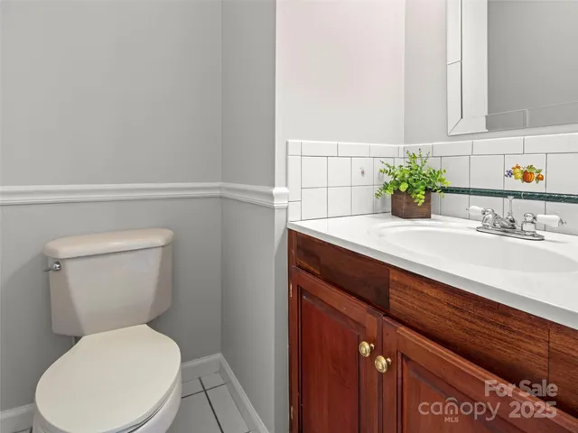 a bathroom with a toilet a sink and a window