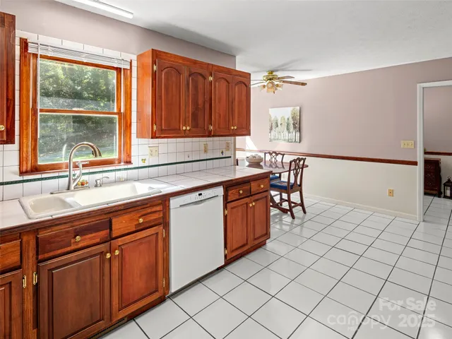 a kitchen with stainless steel appliances a sink and cabinets