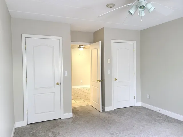 a view of an empty room and a bathroom