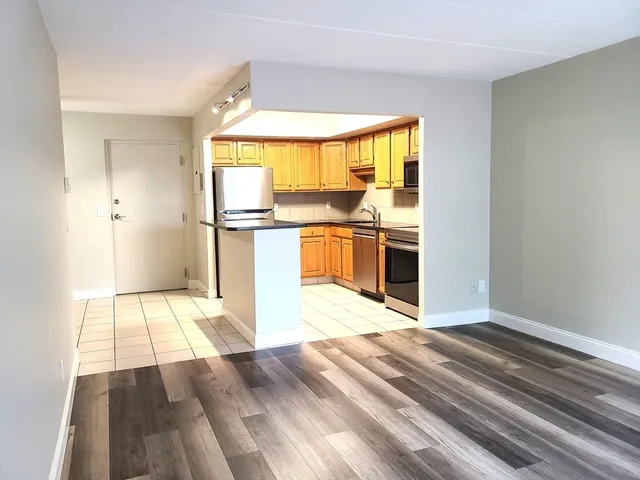 a view of a kitchen with wooden floor and a kitchen