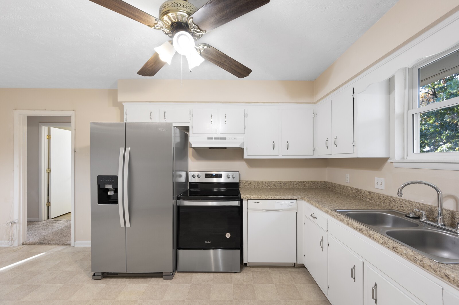 2911 Anderson Road Nashville, TN 37217 - Photo 4 of 14 a kitchen with stainless steel appliances granite countertop a refrigerator a sink a stove and white cabinets