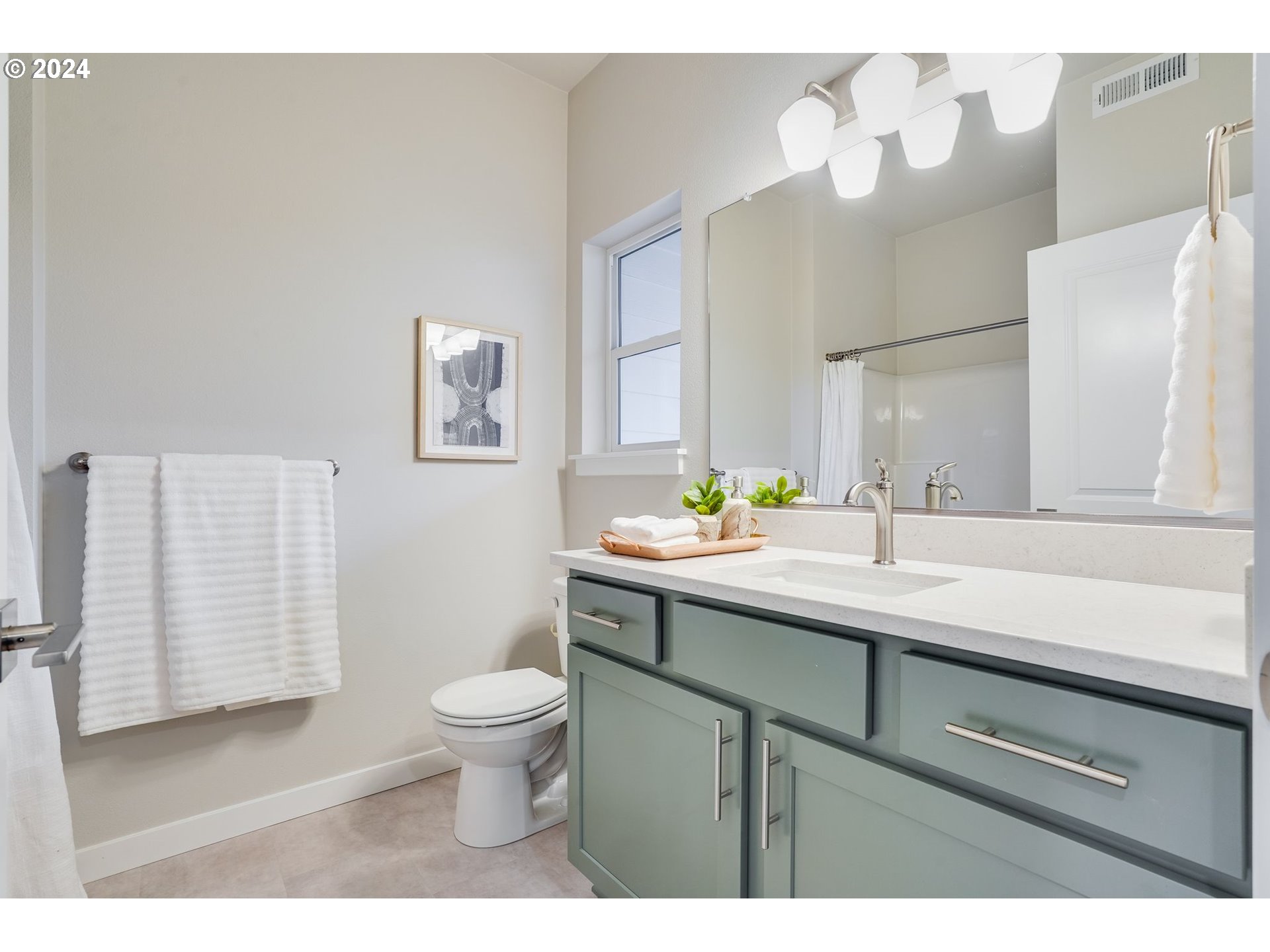 13167 Southwest Carmel Street Tigard, OR 97224 - Photo 13 of 48 a bathroom with a sink a toilet and mirror