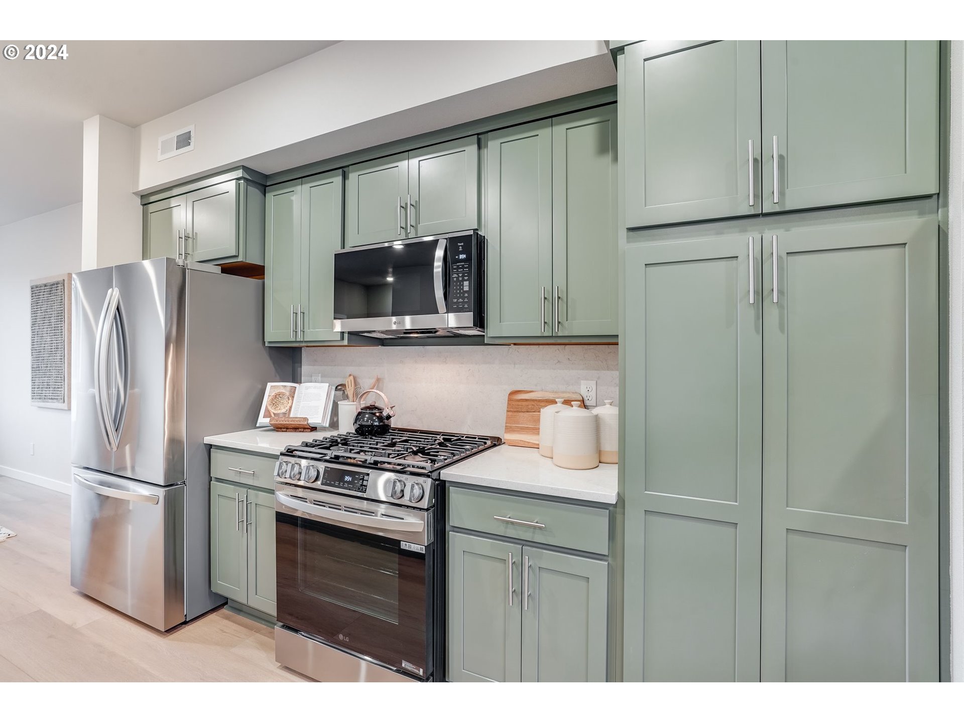 13167 Southwest Carmel Street Tigard, OR 97224 - Photo 22 of 48 a kitchen with stainless steel appliances granite countertop a refrigerator a stove a sink and a microwave