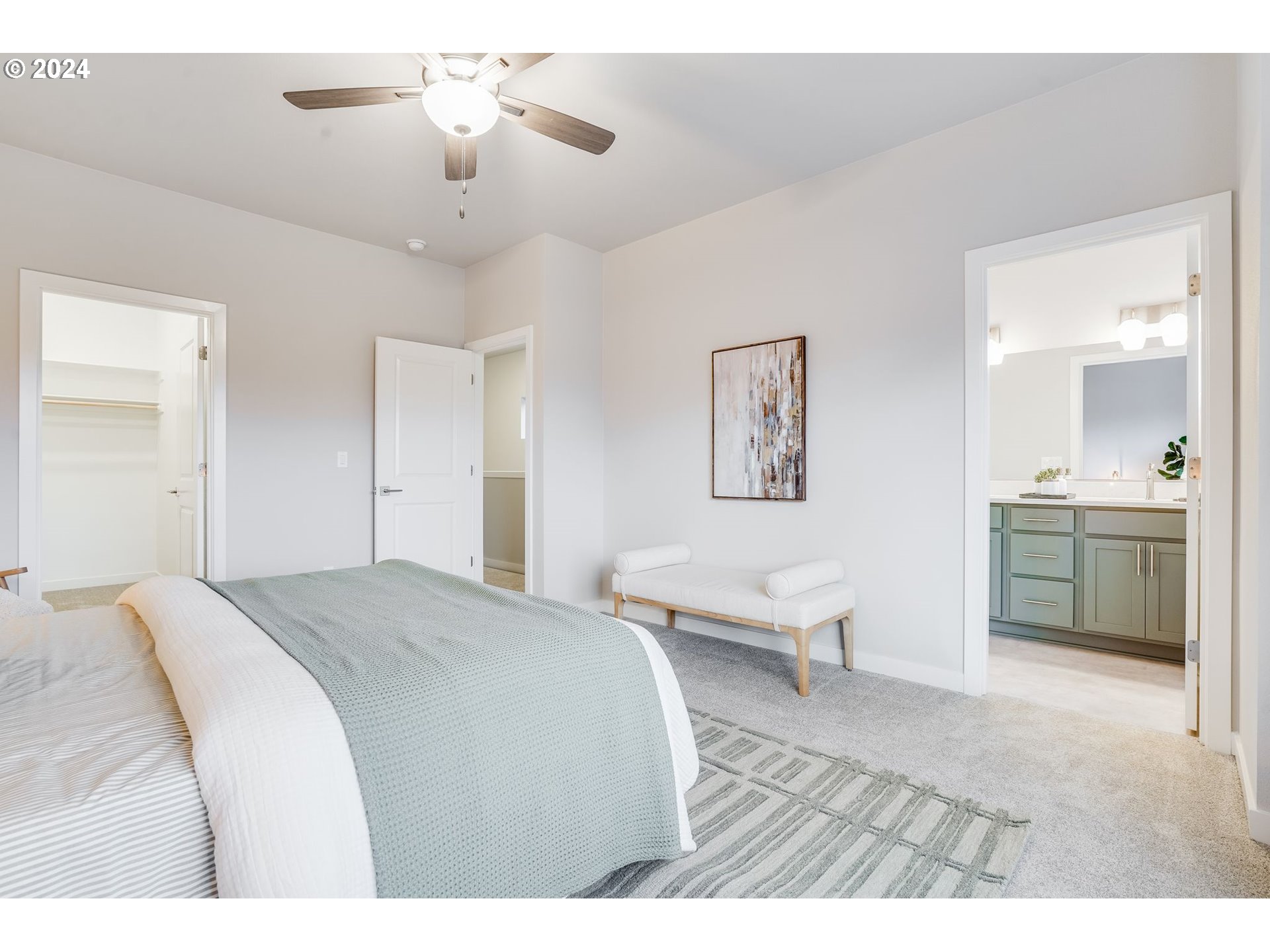 13167 Southwest Carmel Street Tigard, OR 97224 - Photo 29 of 48 a spacious bedroom with a bed and a chandelier
