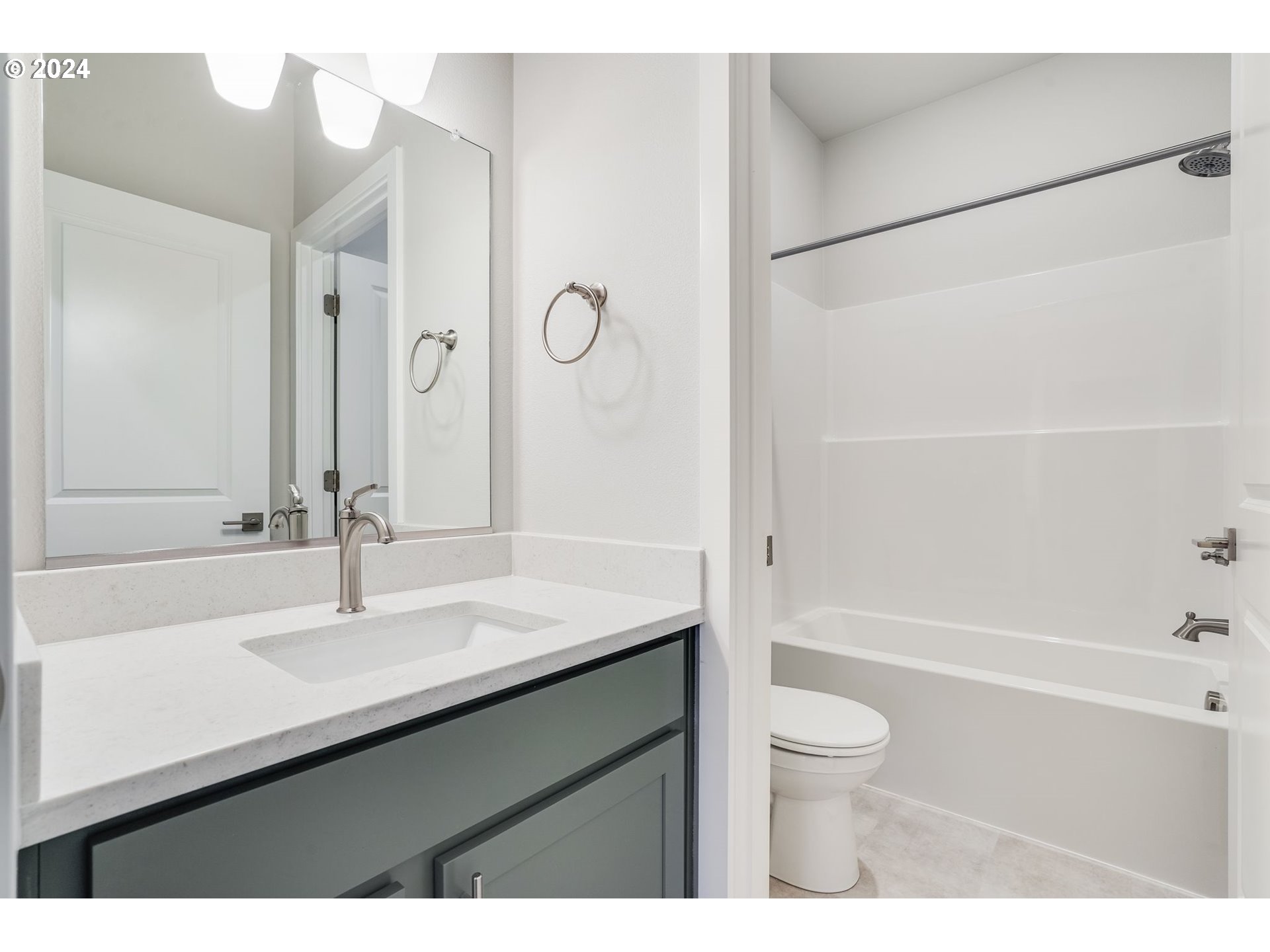 13167 Southwest Carmel Street Tigard, OR 97224 - Photo 37 of 48 a bathroom with a sink a toilet a mirror and shower