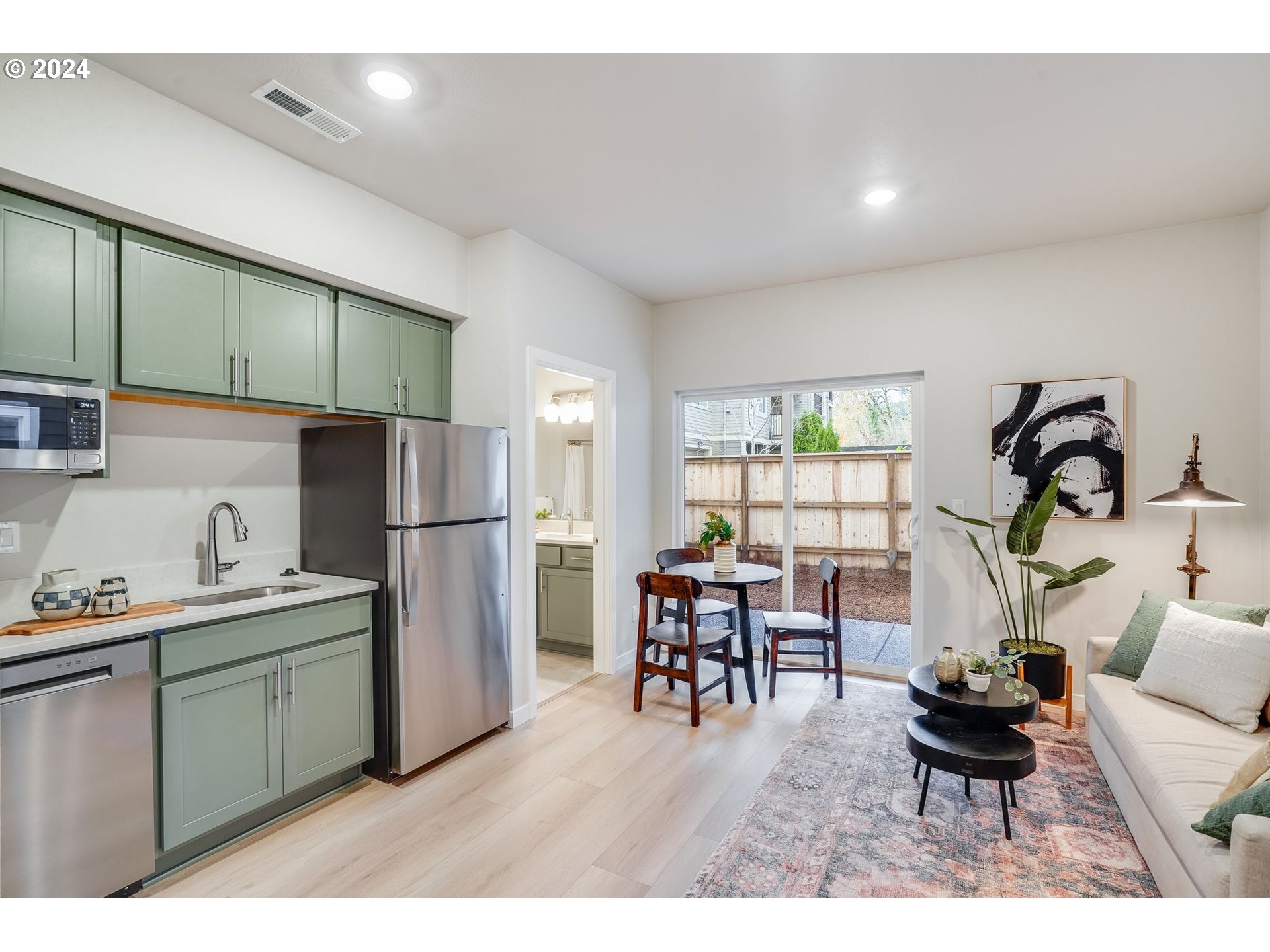 13167 Southwest Carmel Street Tigard, OR 97224 - Photo 8 of 48 a kitchen with a refrigerator and a dining table