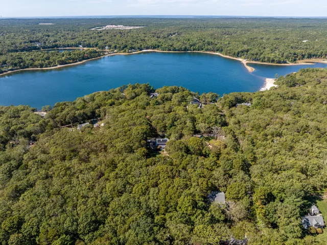 an aerial view of a houses with a lake view