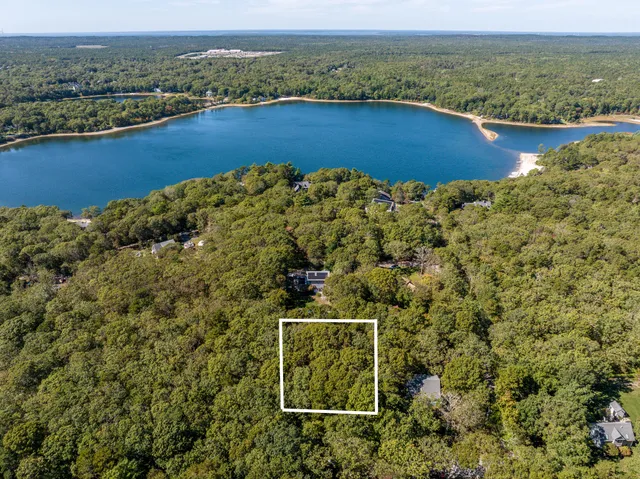 an aerial view of a houses with a lake view