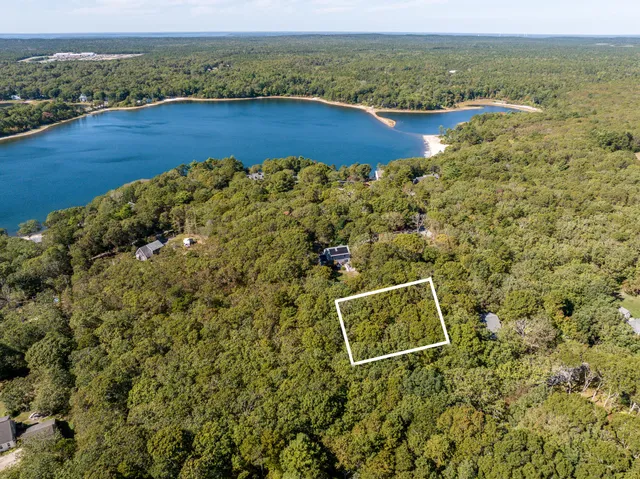 an aerial view of a house with a lake view