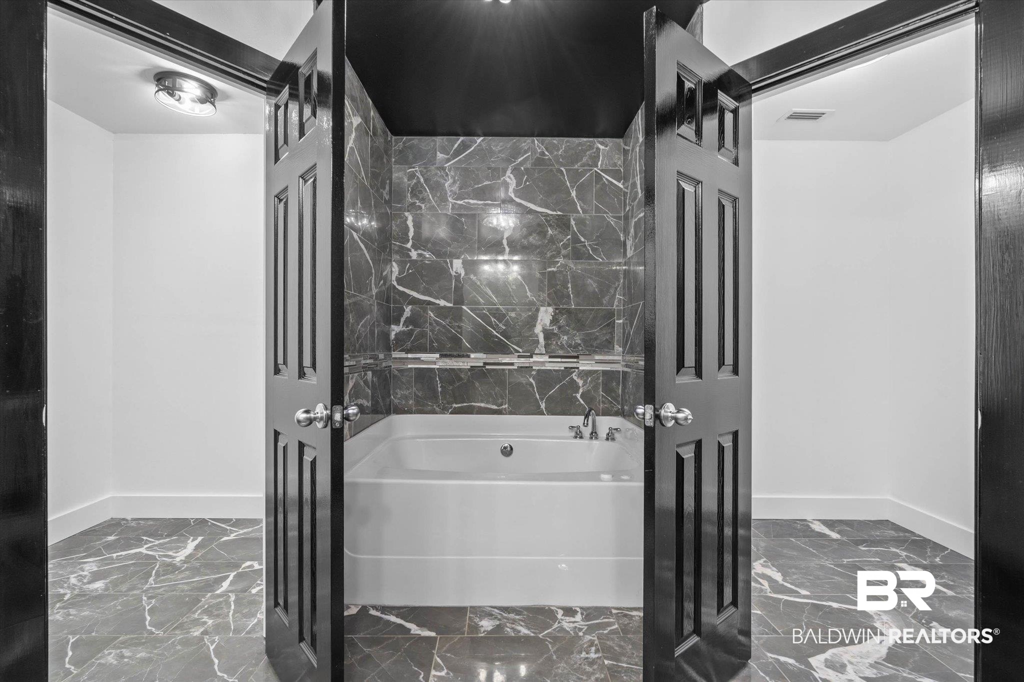 3216 Bay Booster Club Road Theodore, AL 36582 - Photo 15 of 46 Bathroom featuring light marble finish flooring and a garden tub