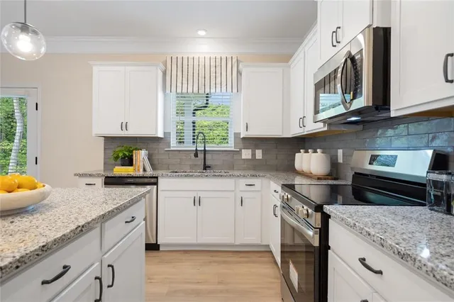 a kitchen with a sink a counter space and stainless steel appliances