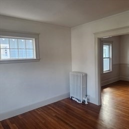 107 Wrentham Street, Unit 2 Boston, MA 02124 - Photo 11 of 20 a view of a room with wooden floor and a window