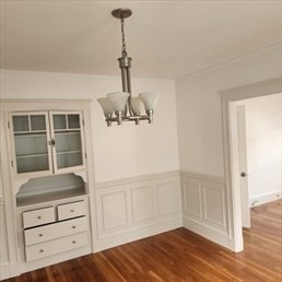 107 Wrentham Street, Unit 2 Boston, MA 02124 - Photo 14 of 20 a view of empty room with wooden floor and cabinet