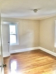 107 Wrentham Street, Unit 2 Boston, MA 02124 - Photo 6 of 20 a view of a room with wooden floor and a window