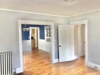 107 Wrentham Street, Unit 2 Boston, MA 02124 - Photo 7 of 20 a view of a hallway with wooden floor and a bathroom