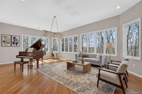 a living room with furniture a fireplace and a large window