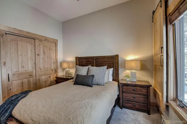 a living room with furniture a rug and a chair