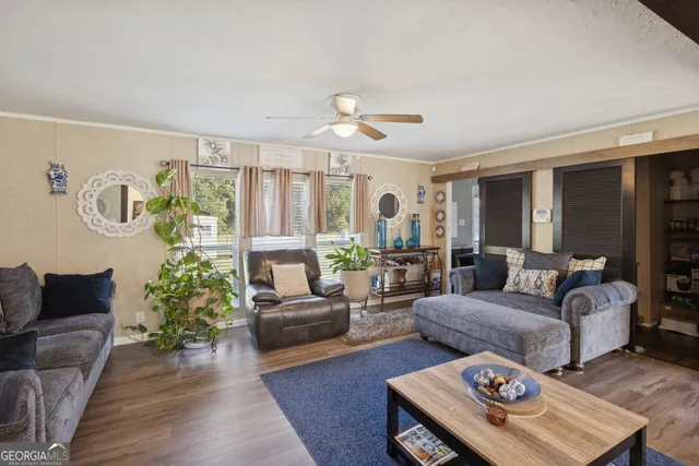 a living room with furniture and wooden floor