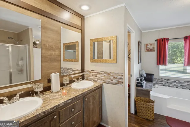 a bathroom with a granite countertop sink and a bathtub