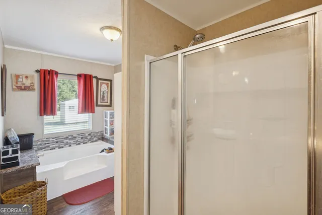 a bathroom with a tub shower and sink