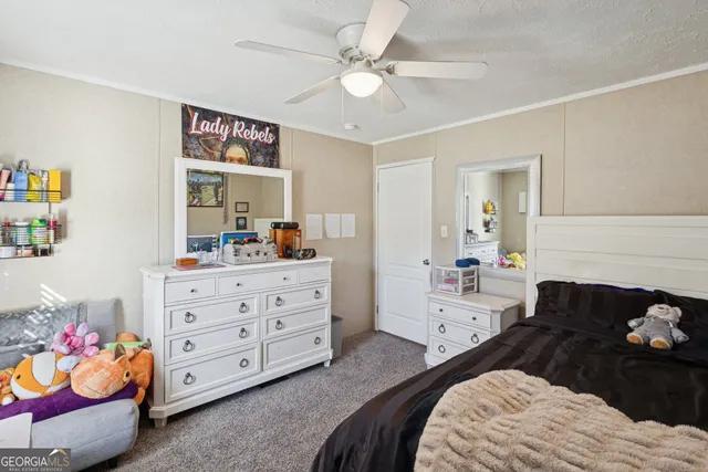 a bedroom with a bed and a dresser in it