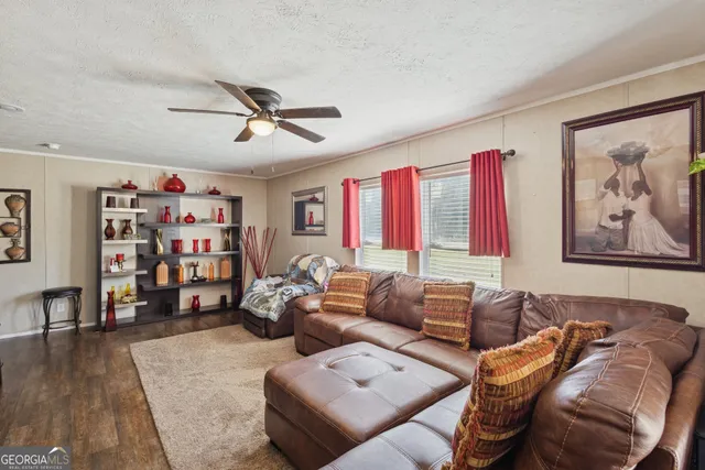 a living room with furniture a couch and a bookshelf