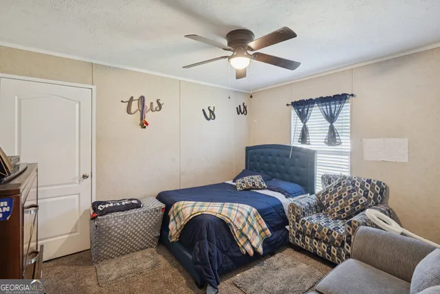 a bedroom with a bed couch and window