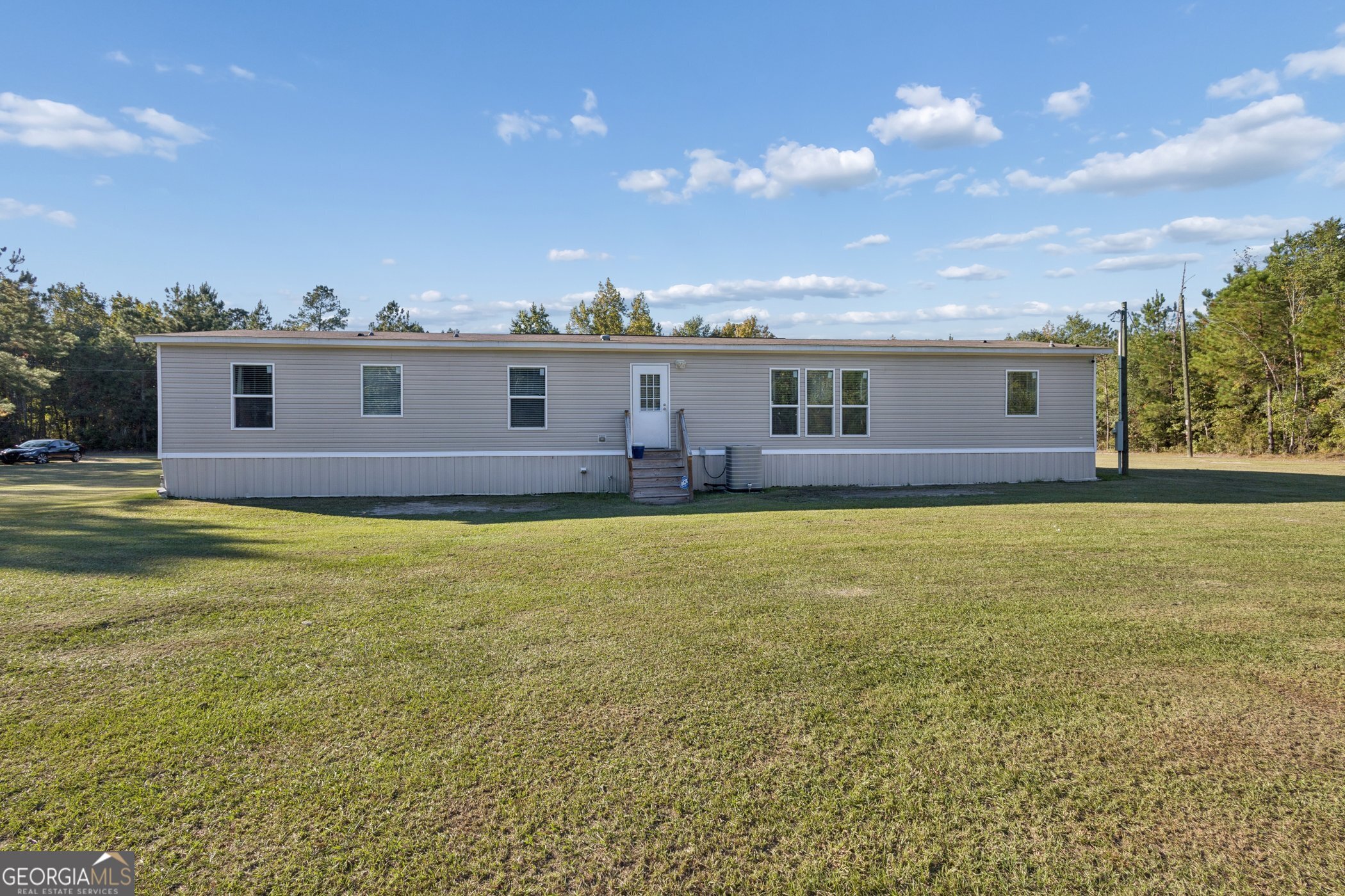 1238 Reedsville Road Clyo, GA 31303 - Photo 27 of 30 a view of a house with a swimming pool and a yard