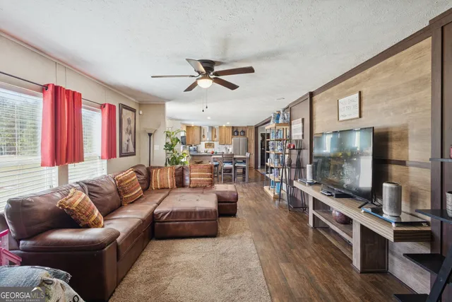 a living room with furniture and a flat screen tv
