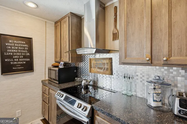 a kitchen with stainless steel appliances granite countertop a stove and a sink