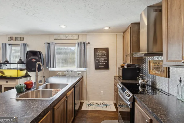 a kitchen with a sink stove and cabinets