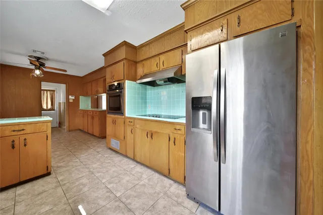 a kitchen with stainless steel appliances a refrigerator and a stove