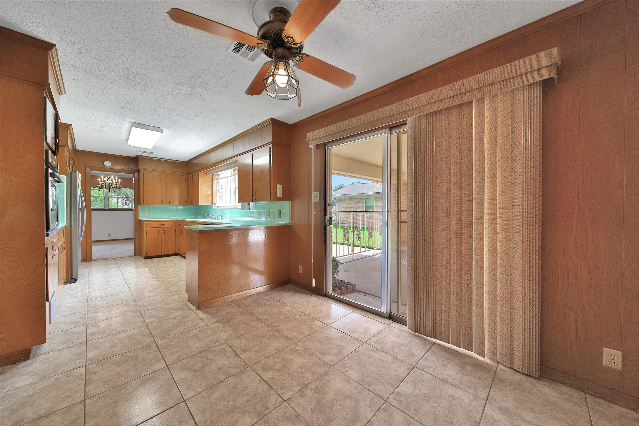 115 East Thornton Road Houston, TX 77022 - Photo 14 of 40 a view of a kitchen with furniture and a ceiling fan