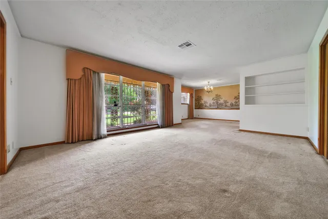 a view of a livingroom with an empty space and balcony