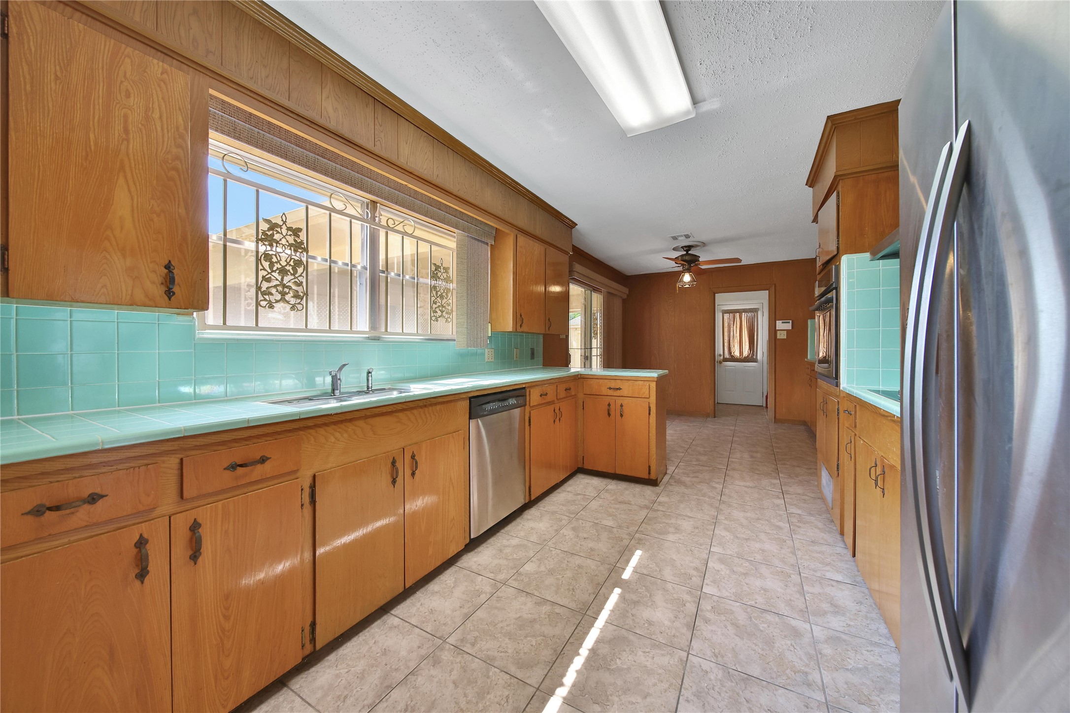 115 East Thornton Road Houston, TX 77022 - Photo 10 of 40 a large kitchen with stainless steel appliances granite countertop a refrigerator and a sink