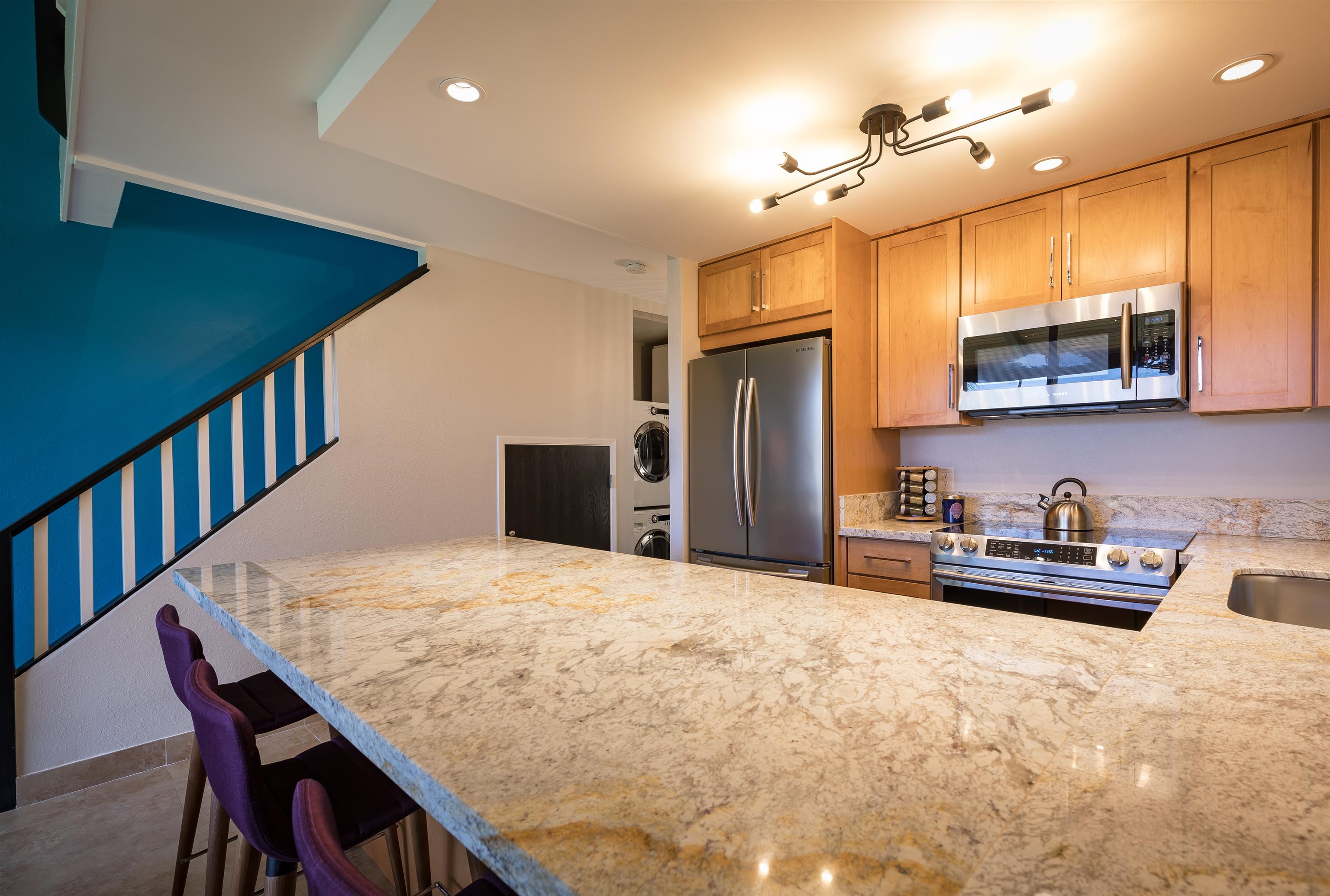 940 South Kihei Road, Unit B309 Kihei, HI 96753 - Photo 17 of 29 a kitchen with stainless steel appliances granite countertop a sink refrigerator stove microwave and cabinets