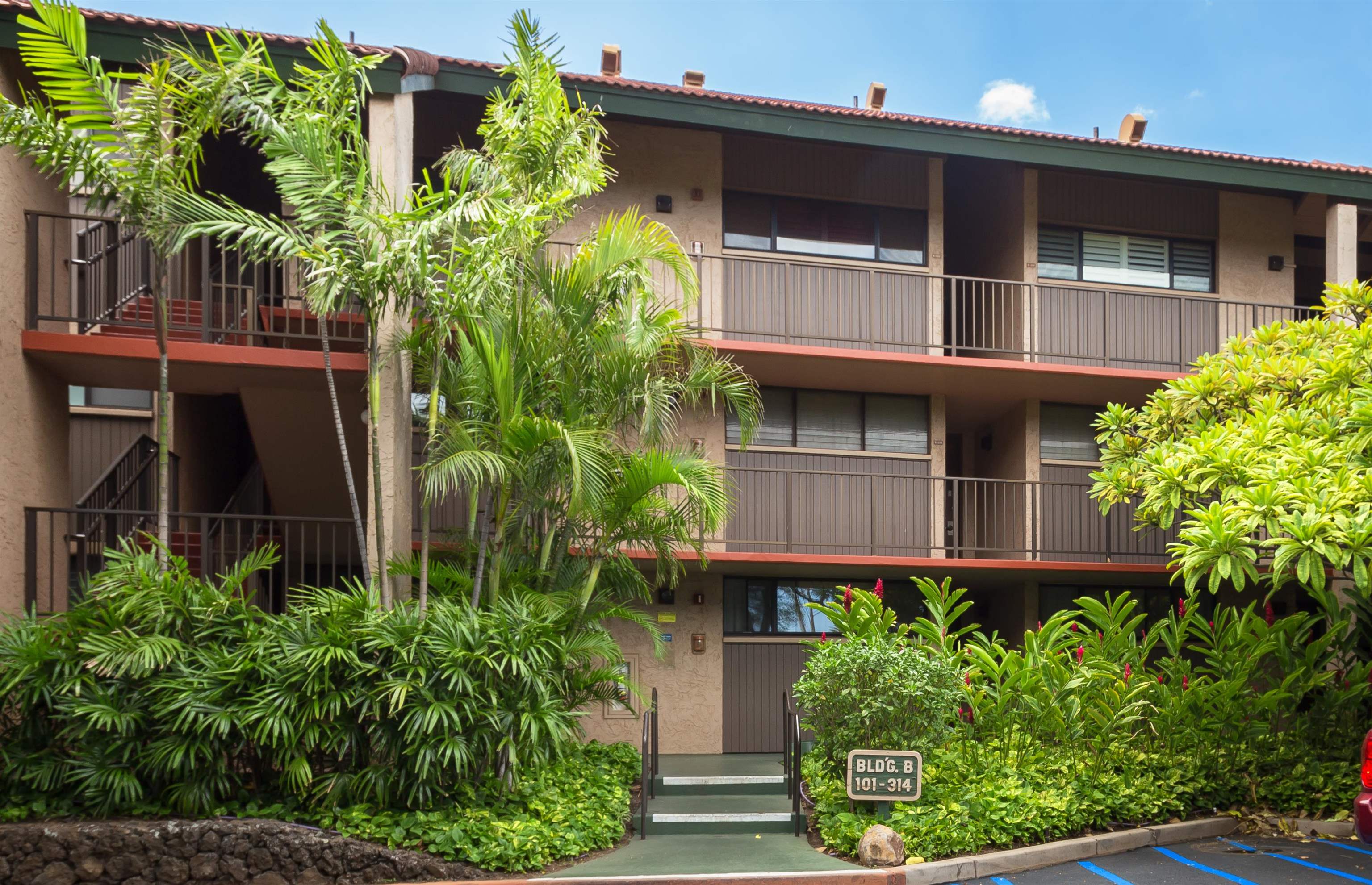 940 South Kihei Road, Unit B309 Kihei, HI 96753 - Photo 27 of 29 a house with a flower garden in front of it