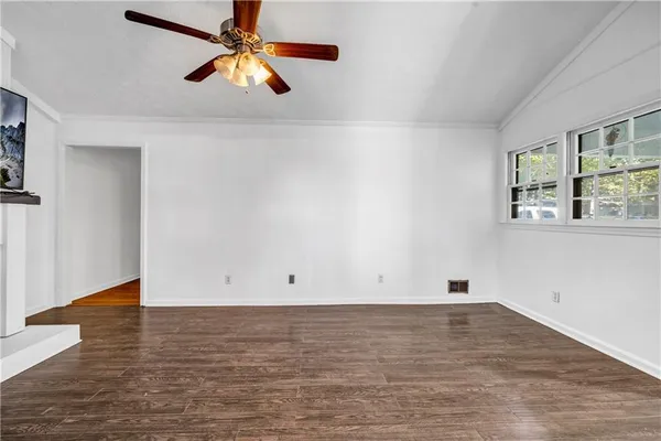wooden floor in an empty room with a window