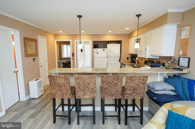 a dining table chairs and a kitchen view