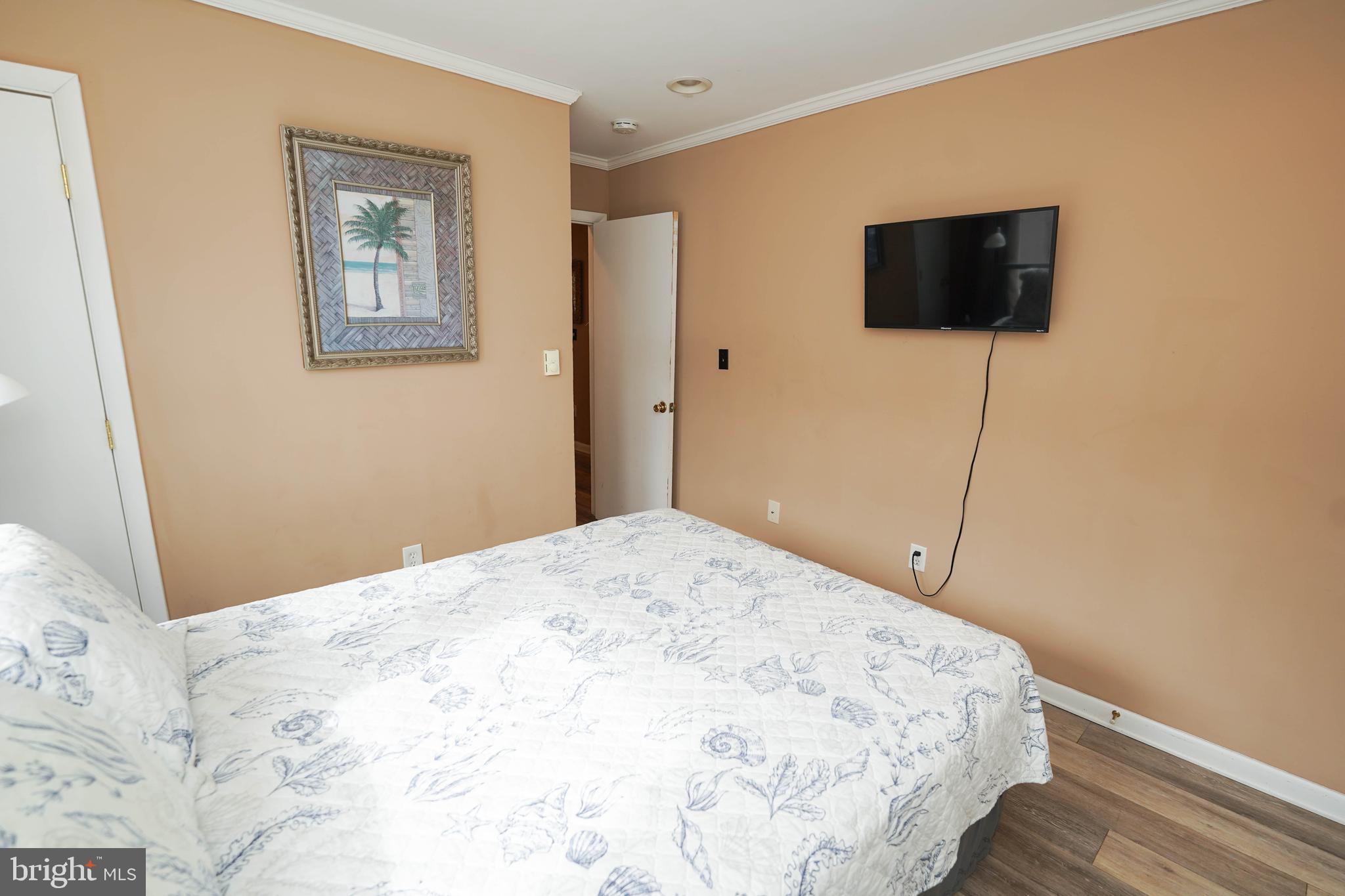 17 139th Street, Unit 101 Ocean City, MD 21842 - Photo 23 of 28 a bedroom with a bed and a flat screen tv