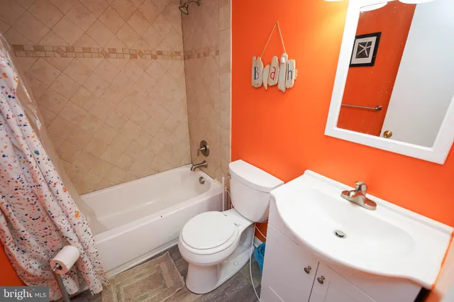 a white toilet sitting next to a bathroom sink