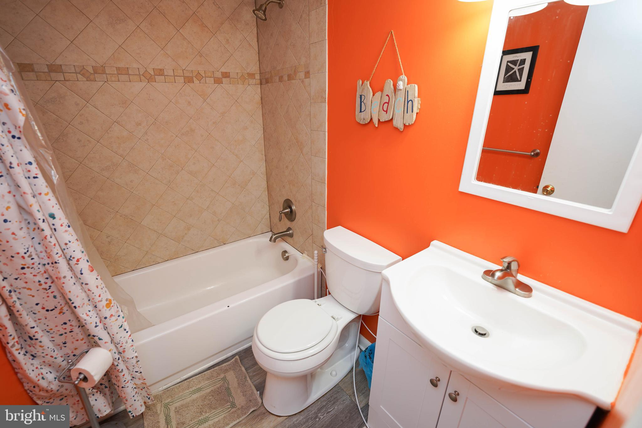 17 139th Street, Unit 101 Ocean City, MD 21842 - Photo 25 of 28 a white toilet sitting next to a bathroom sink