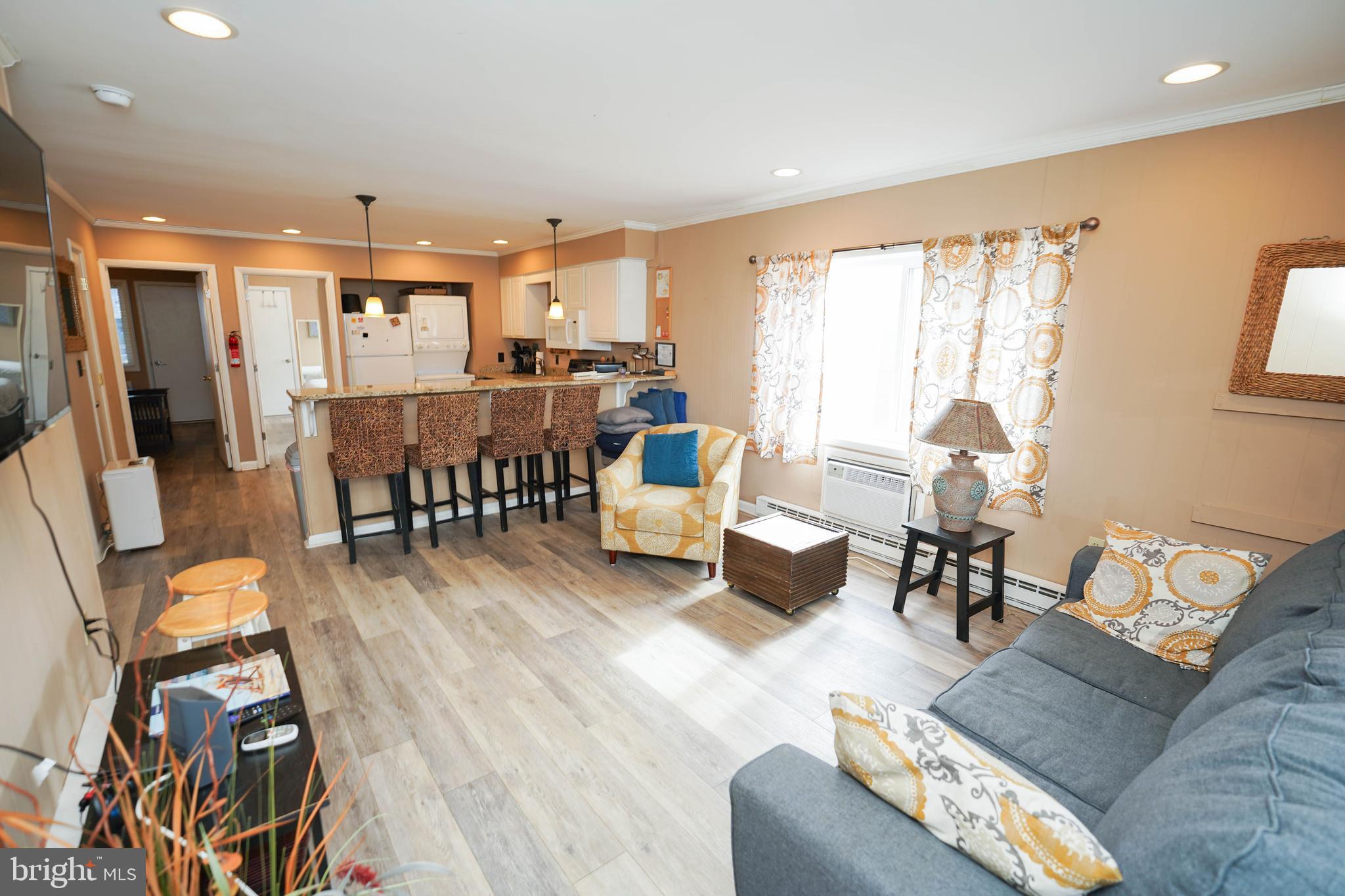 17 139th Street, Unit 101 Ocean City, MD 21842 - Photo 9 of 28 a living room with furniture and a large window