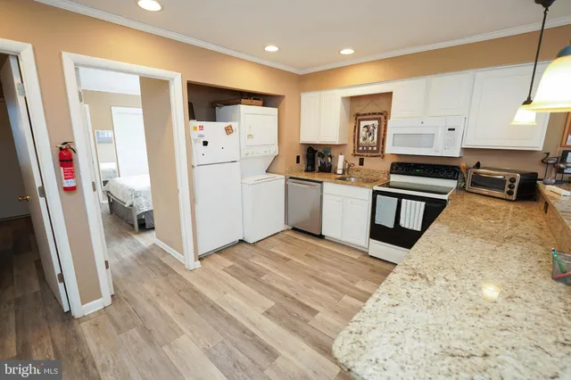 a kitchen with a sink appliances and cabinets