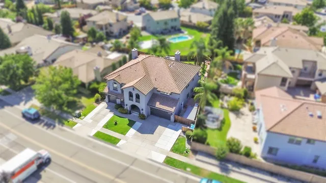 an aerial view of a house with a yard and garden