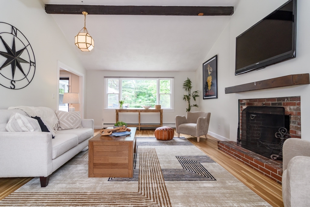 124 Everett Street Natick, MA 01760 - Photo 6 of 36 a living room with furniture a flat screen tv and a fireplace