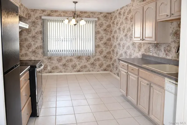 a view of a livingroom with an empty space and a window
