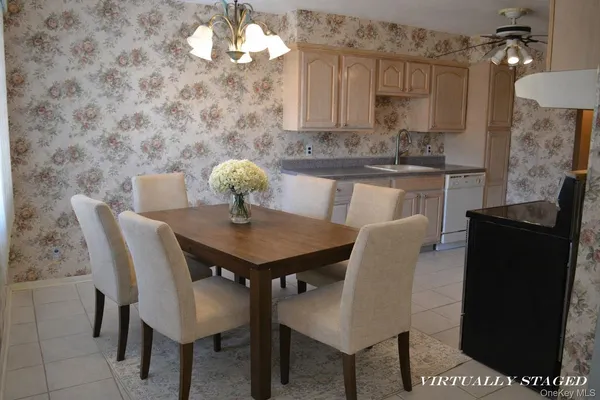 a spacious bedroom with a bed and wooden floor