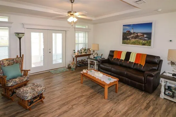 a living room with furniture and a wooden floor