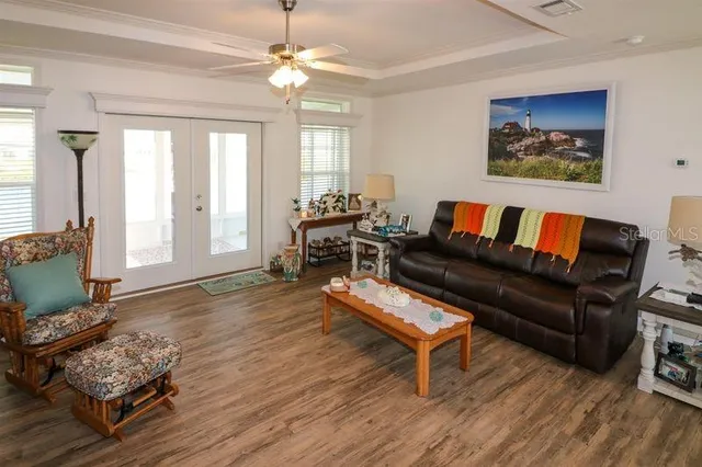 a living room with furniture and a wooden floor